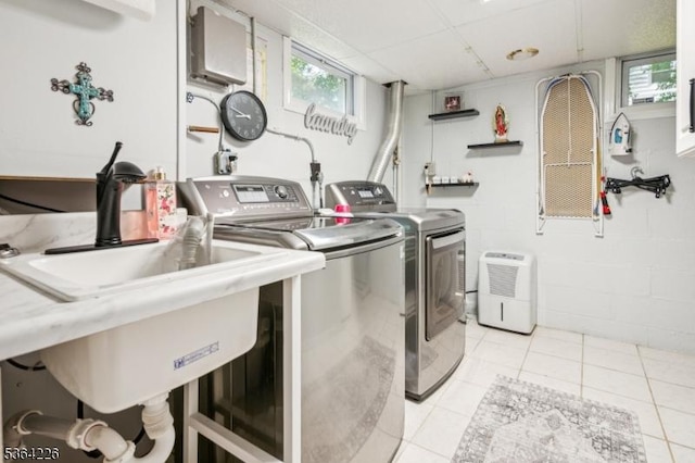 1707 Valley Rd, Long Hill Twp, NJ 07946 - laundry room featuring washer and clothes dryer, light tile patterned floors, and concrete block wall
