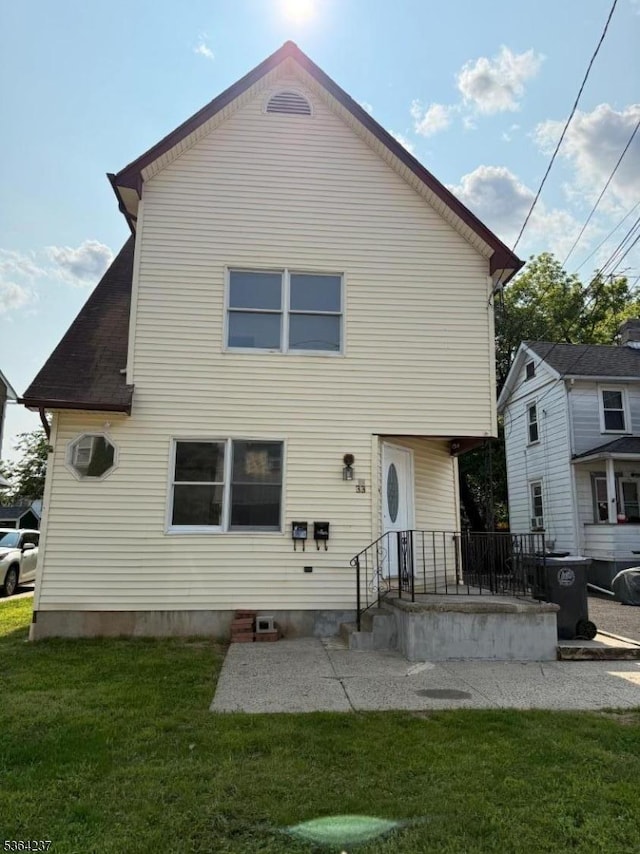 33 Fisher Ave, Bound Brook Boro, NJ 08805 - back of house with a lawn and a patio