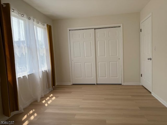 33 Fisher Ave, Bound Brook Boro, NJ 08805 - unfurnished bedroom with light wood-style floors and a closet