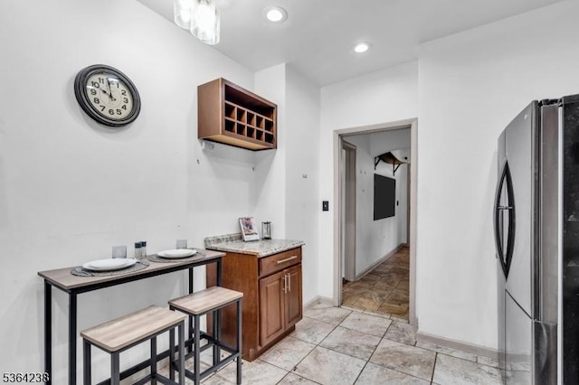1332 Maple Ter, Rahway City, NJ 07065 - kitchen featuring freestanding refrigerator, brown cabinets, recessed lighting, open shelves, and light stone countertops