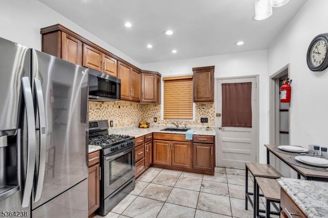 1332 Maple Ter, Rahway City, NJ 07065 - kitchen featuring stainless steel appliances, decorative backsplash, recessed lighting, brown cabinets, and light stone countertops