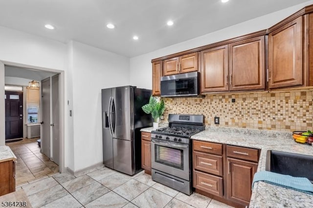 1332 Maple Ter, Rahway City, NJ 07065 - kitchen featuring stainless steel appliances, tasteful backsplash, brown cabinetry, and recessed lighting