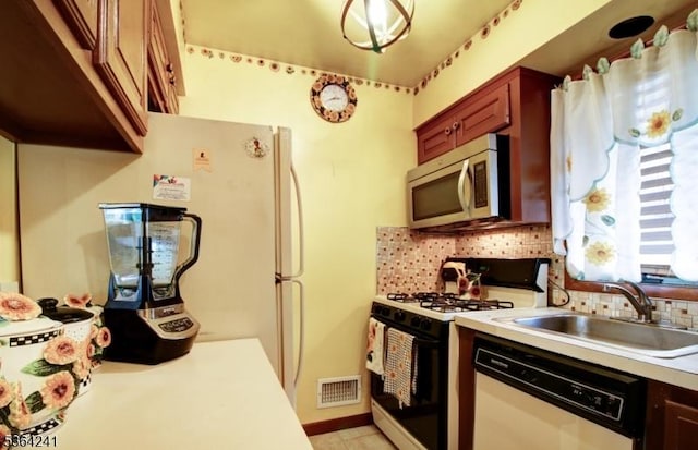 6 Essex St Unit F-32, Belleville Twp, NJ 07109 - kitchen with white appliances, decorative backsplash, light countertops, and light tile patterned floors