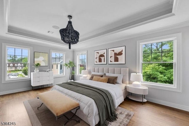 4 Hanover Rd Unit 1, Florham Park Boro, NJ 07932 - bedroom with a tray ceiling, ornamental molding, wood finished floors, and a chandelier