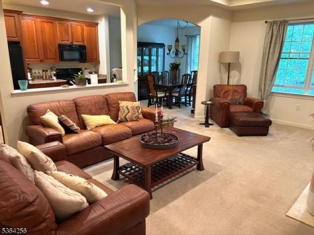28 Ridgeview Ln, Mount Arlington Boro, NJ 07856 - living room featuring a chandelier, arched walkways, light carpet, and recessed lighting