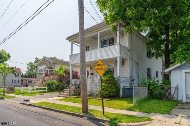 684 Harrison St, Rahway City, NJ 07065 - view of front facade with brick siding, covered porch, and a balcony