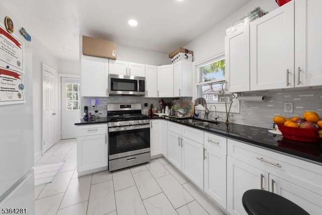 684 Harrison St, Rahway City, NJ 07065 - kitchen featuring appliances with stainless steel finishes, tasteful backsplash, white cabinets, and recessed lighting