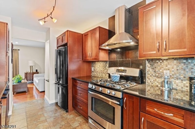 1200 Springfield Ave Unit 3A, New Providence Boro, NJ 07974 - kitchen featuring gas range, wall chimney exhaust hood, freestanding refrigerator, dark stone counters, and decorative backsplash