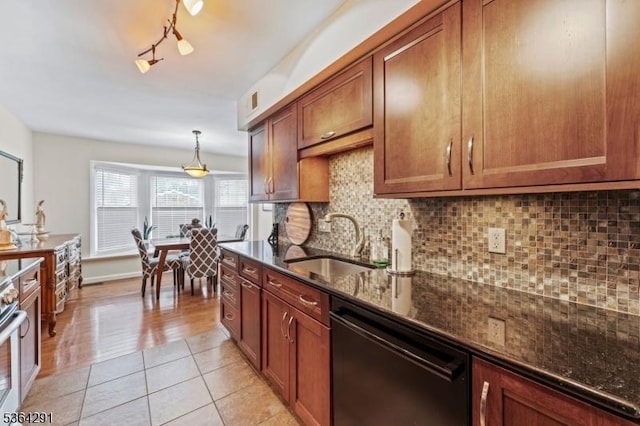 1200 Springfield Ave Unit 3A, New Providence Boro, NJ 07974 - kitchen with dishwasher, dark stone counters, light tile patterned floors, brown cabinets, and tasteful backsplash
