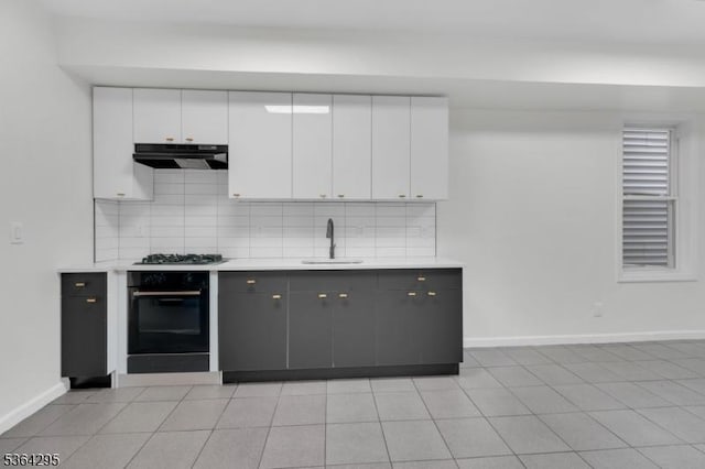 158 Catherine St Unit A/B, Elizabeth City, NJ 07201 - kitchen featuring oven, exhaust hood, decorative backsplash, white cabinets, and gas cooktop