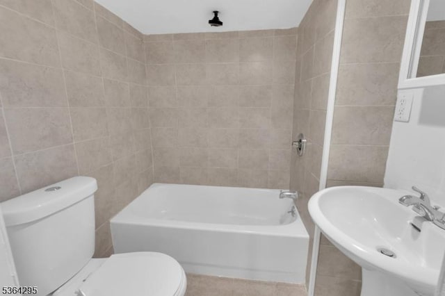 158 Catherine St Unit A/B, Elizabeth City, NJ 07201 - bathroom with shower / bathtub combination, tile patterned flooring, and tile walls