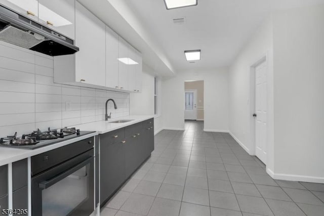 158 Catherine St Unit A/B, Elizabeth City, NJ 07201 - kitchen featuring under cabinet range hood, black appliances, light countertops, tasteful backsplash, and white cabinets