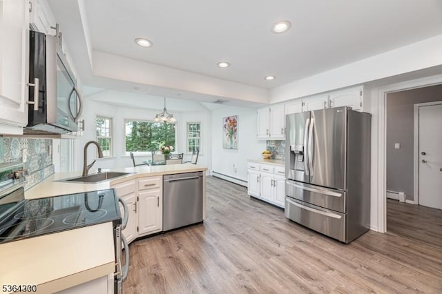 1 Warwick Dr, Washington Twp, NJ 07853 - kitchen with stainless steel appliances, light wood-style flooring, a peninsula, white cabinetry, and recessed lighting