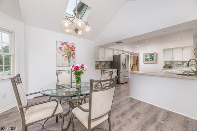 1 Warwick Dr, Washington Twp, NJ 07853 - dining area with light wood-style flooring, lofted ceiling, and a chandelier