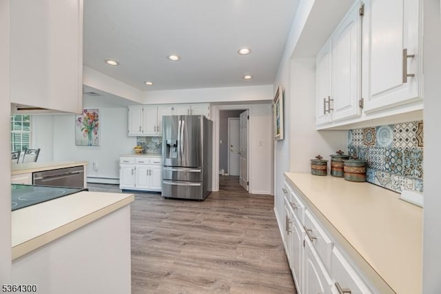 1 Warwick Dr, Washington Twp, NJ 07853 - kitchen featuring stainless steel appliances, baseboard heating, light countertops, decorative backsplash, and white cabinetry