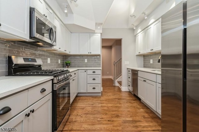 9 Somerset Pl, West Milford Twp, NJ 07480 - kitchen featuring appliances with stainless steel finishes, light countertops, backsplash, light wood-style flooring, and white cabinets