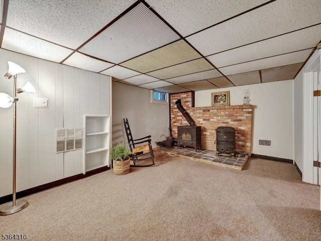 23 Felter Pl, Jefferson Twp, NJ 07849 - sitting room with a wood stove, carpet flooring, and a drop ceiling