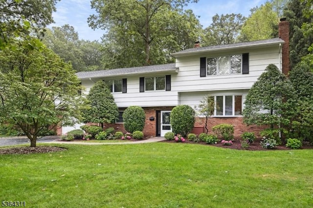 2242 Shawnee Path, Scotch Plains Twp, NJ 07076 - split level home featuring a chimney, a front yard, and brick siding