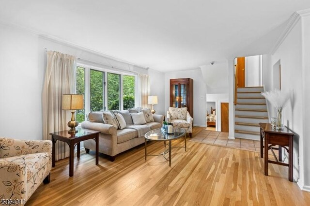 2242 Shawnee Path, Scotch Plains Twp, NJ 07076 - living area with light wood-type flooring, stairway, and crown molding