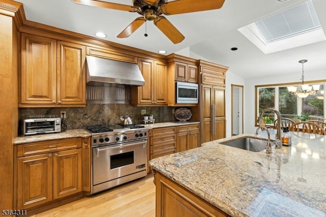 2242 Shawnee Path, Scotch Plains Twp, NJ 07076 - kitchen featuring built in appliances, extractor fan, brown cabinets, a skylight, and a chandelier