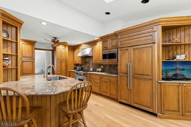2242 Shawnee Path, Scotch Plains Twp, NJ 07076 - kitchen with open shelves, built in appliances, range hood, brown cabinets, and light stone counters