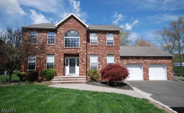 58 Greenbrook Rd, Green Brook Twp, NJ 08812 - colonial-style house featuring asphalt driveway, brick siding, a garage, a front lawn, and a shingled roof