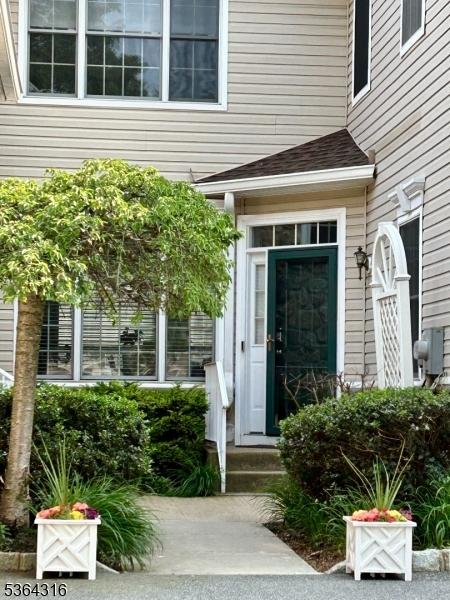 7 Whalen Ct, West Orange Twp, NJ 07052 - property entrance with a shingled roof