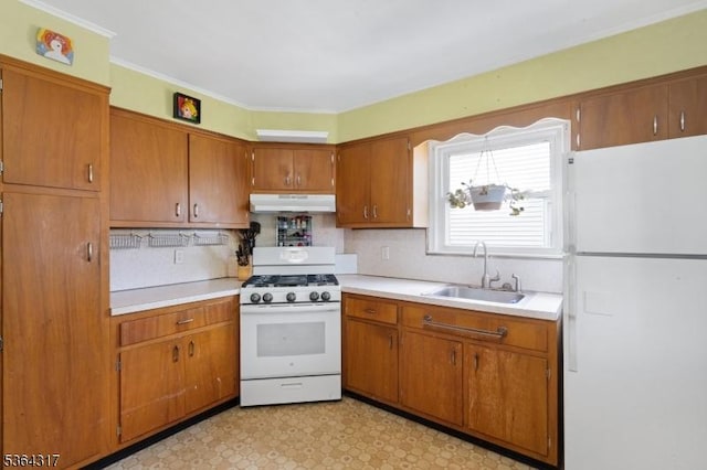 520 Marion St, Bound Brook Boro, NJ 08805 - kitchen with white appliances, under cabinet range hood, light countertops, brown cabinets, and tasteful backsplash