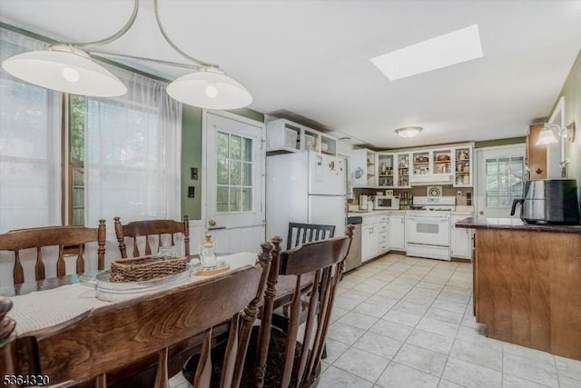 53 Lonaconing Rd, Vernon Twp, NJ 07422 - kitchen featuring white appliances, light tile patterned floors, a skylight, glass insert cabinets, and open shelves