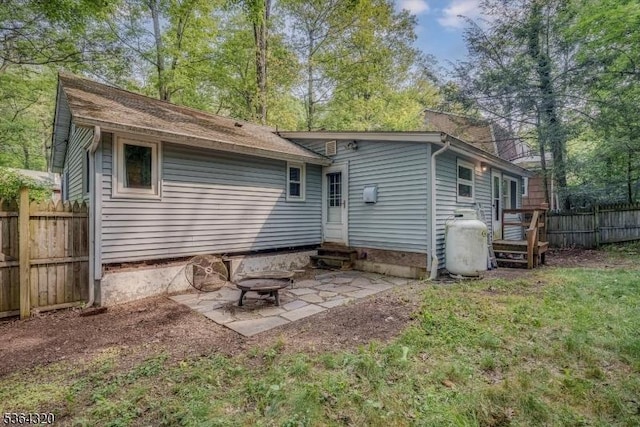 53 Lonaconing Rd, Vernon Twp, NJ 07422 - rear view of house with entry steps, a fire pit, and a patio