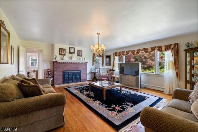 87 S Ridgedale Ave, East Hanover Twp, NJ 07936 - living room featuring a chandelier, wood finished floors, baseboard heating, and a brick fireplace