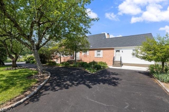 87 S Ridgedale Ave, East Hanover Twp, NJ 07936 - view of front facade featuring entry steps, driveway, a chimney, and brick siding