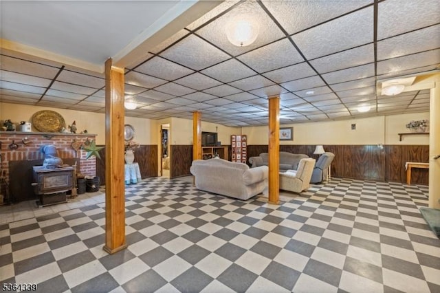 87 S Ridgedale Ave, East Hanover Twp, NJ 07936 - finished below grade area featuring a drop ceiling, tile patterned floors, a wainscoted wall, a wood stove, and wood walls