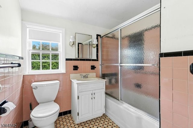 203 Beech St, Cranford Twp, NJ 07016 - bathroom featuring tile walls, enclosed tub / shower combo, vanity, a wainscoted wall, and tile patterned floors