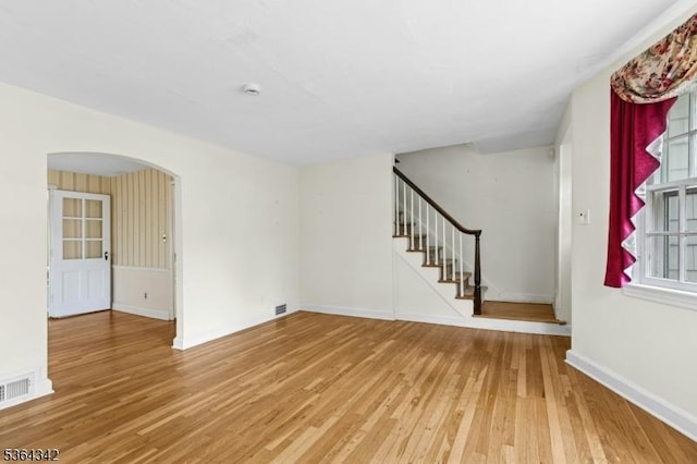 203 Beech St, Cranford Twp, NJ 07016 - unfurnished living room with wood finished floors, arched walkways, and stairs