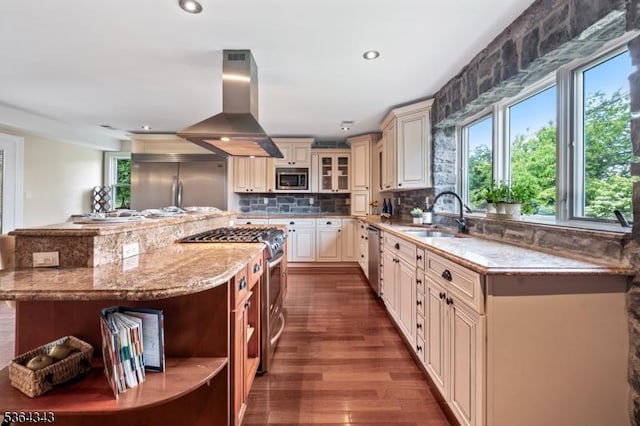 231 Woods Rd, Hillsborough Twp, NJ 08844 - kitchen with cream cabinetry, built in appliances, island range hood, decorative backsplash, and light stone counters