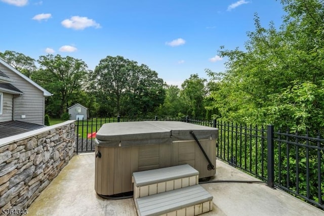 231 Woods Rd, Hillsborough Twp, NJ 08844 - view of patio / terrace featuring a hot tub, a storage unit, and view of wooded area