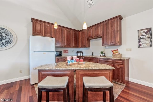 231 Woods Rd, Hillsborough Twp, NJ 08844 - kitchen featuring freestanding refrigerator, dark wood finished floors, a breakfast bar, lofted ceiling, and pendant lighting