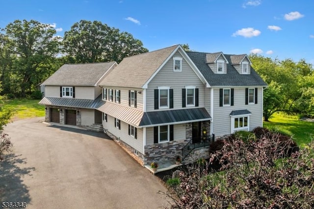 231 Woods Rd, Hillsborough Twp, NJ 08844 - view of front of home with a standing seam roof, a metal roof, driveway, a porch, and stone siding