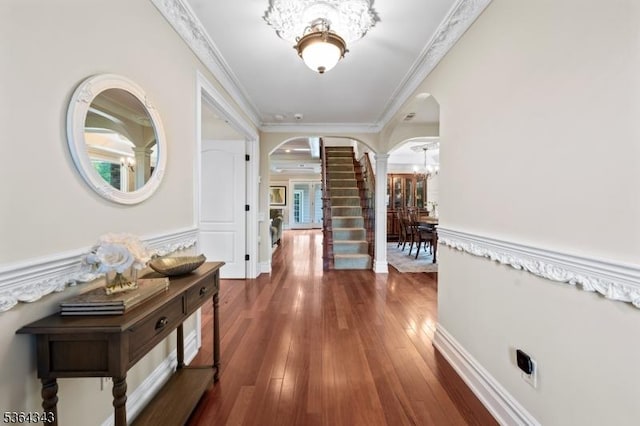 231 Woods Rd, Hillsborough Twp, NJ 08844 - hall with arched walkways, a chandelier, dark wood finished floors, crown molding, and decorative columns