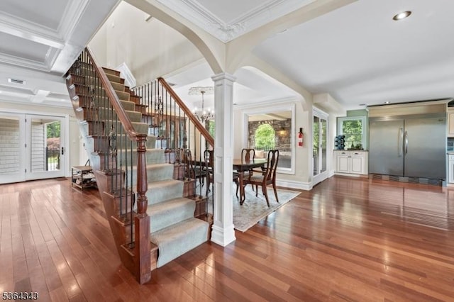 231 Woods Rd, Hillsborough Twp, NJ 08844 - staircase with ornate columns, hardwood / wood-style flooring, plenty of natural light, crown molding, and arched walkways