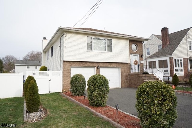 44 Joseph St, Clark Twp, NJ 07066 - view of front of home with brick siding, a garage, and asphalt driveway