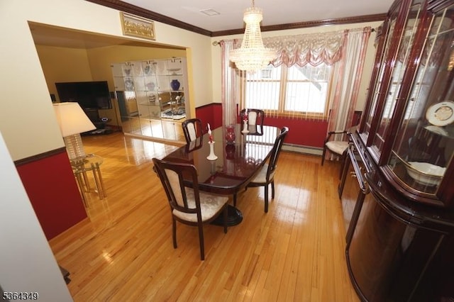 44 Joseph St, Clark Twp, NJ 07066 - dining space featuring a chandelier, crown molding, baseboard heating, and light wood-style floors