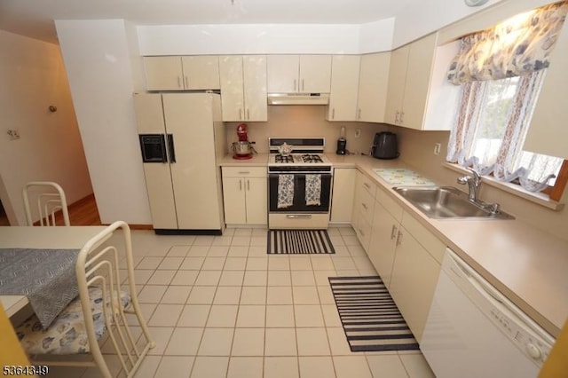 44 Joseph St, Clark Twp, NJ 07066 - kitchen with white appliances, under cabinet range hood, light countertops, and light tile patterned floors