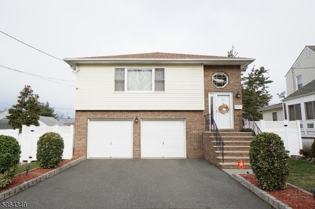 44 Joseph St, Clark Twp, NJ 07066 - view of front facade with brick siding, driveway, and a garage
