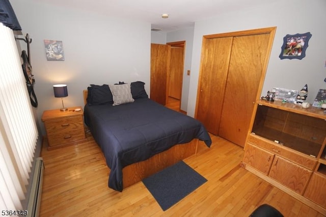 44 Joseph St, Clark Twp, NJ 07066 - bedroom with light wood-type flooring, a baseboard heating unit, and a closet