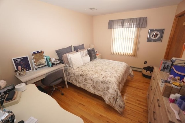 44 Joseph St, Clark Twp, NJ 07066 - bedroom with light wood-type flooring and a baseboard heating unit