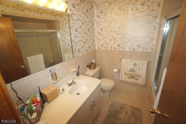 44 Joseph St, Clark Twp, NJ 07066 - bathroom featuring wallpapered walls, an enclosed shower, a wainscoted wall, vanity, and tile walls