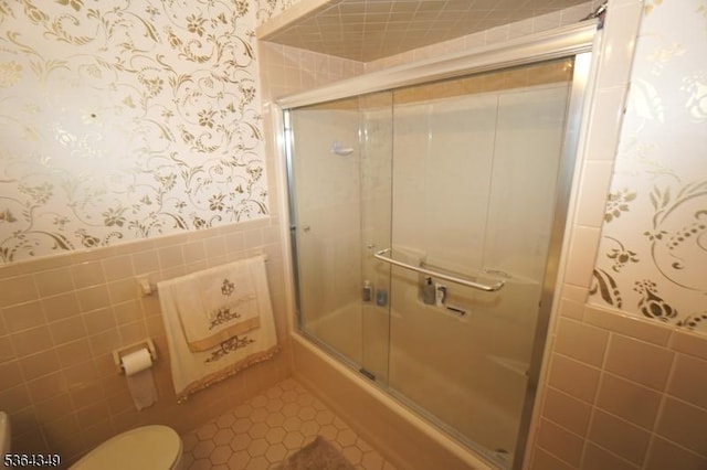 44 Joseph St, Clark Twp, NJ 07066 - bathroom with wallpapered walls, tile walls, a wainscoted wall, tile patterned floors, and combined bath / shower with glass door