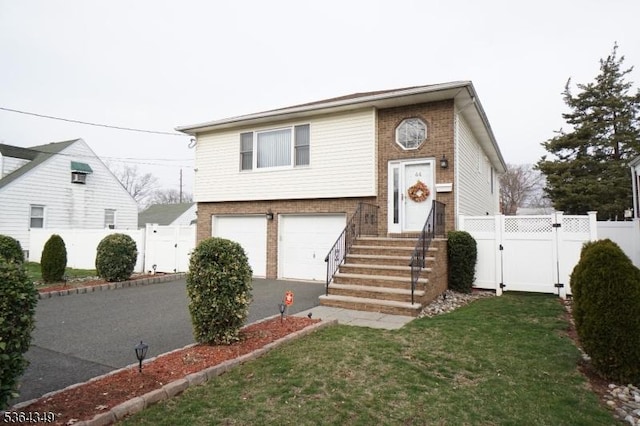 44 Joseph St, Clark Twp, NJ 07066 - split foyer home with brick siding, a garage, driveway, and a gate
